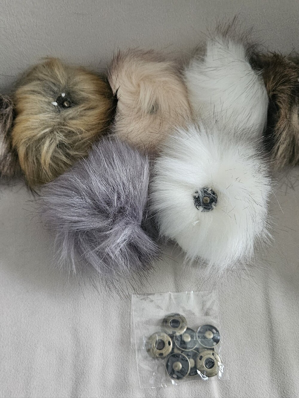 Nine New Pom Poms Plus a unopened bag of snaps included.